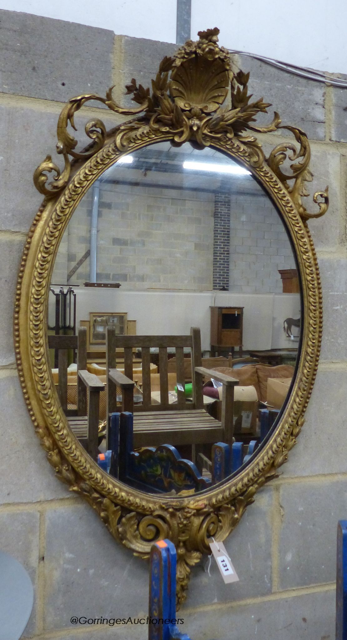 A Victorian giltwood and gesso oval wall mirror, width 58cm, height 100cm